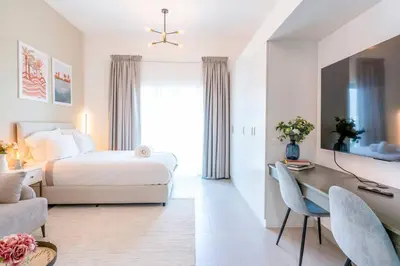 a hotel room with a bed and a desk and a bedroom at Best Place 2B Dubai in Dubai