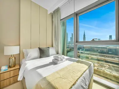 a bedroom with a bed and a large window at Premium Two-Bedroom Apartment with Private Balcony & Full Burj Khalifa Views by Al Fannan Holiday Homes in Dubai