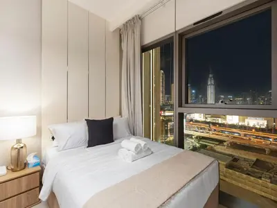 a bedroom with a bed with a large window at Premium Two-Bedroom Apartment with Private Balcony & Full Burj Khalifa Views by Al Fannan Holiday Homes in Dubai