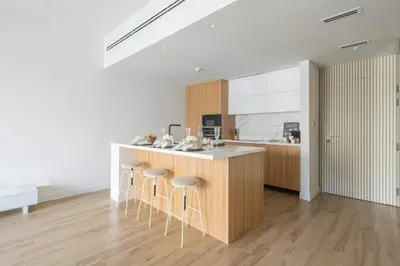 a kitchen with a counter and stools in a room at Frank Porter - Al Dhafrah 2 in Dubai