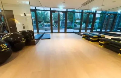 a gym with dumbbells and pads on a wooden floor at FAM Living - Address Residences Opera - Luxurious 2Bed in Dubai