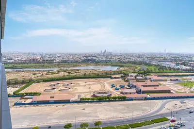 an aerial view of a park with a city in the background at Canal View, 1BR, Terrace I Gym, Pool, Parking in Dubai
