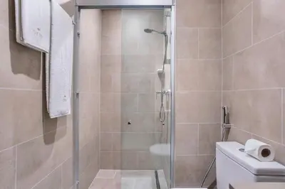 a shower stall in a bathroom with a toilet at STAY BY LATINEM Luxury 1BR Holiday Home CVR B2303 near Burj Khalifa in Dubai