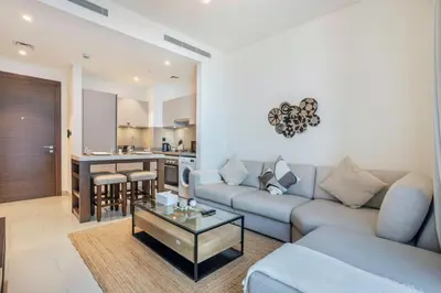 a living room with a couch and a table at STAY BY LATINEM Luxury 1BR Holiday Home CVR B2303 near Burj Khalifa in Dubai
