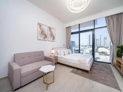 a living room with a bed and a couch at Chic Studio Azizi Riviera Retreat with City Views in Dubai