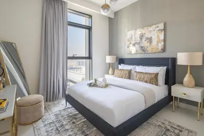 a bedroom with a large bed and a large window at Frank Porter - Marina Vista 2 in Dubai