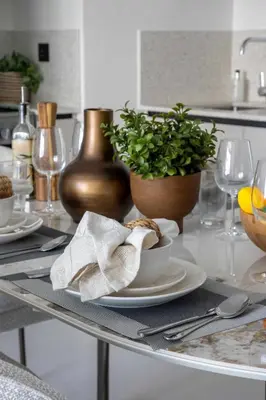 a table with plates of food and a plant on it at Frank Porter - Marina Vista 2 in Dubai