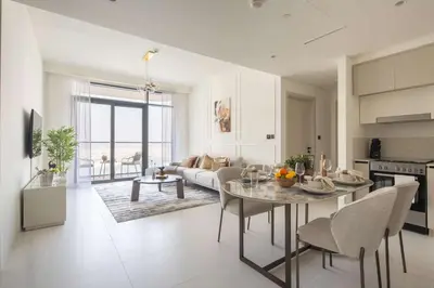 a kitchen and living room with a table and a couch at Frank Porter - Marina Vista 2 in Dubai