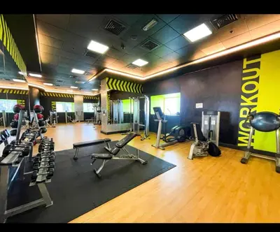 a gym with several treadmills and machines in a room at Stunning SeaView Elite Residence Dubai Marina in Dubai