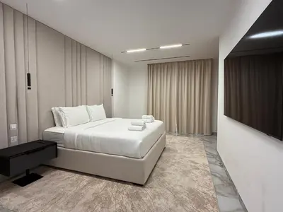 a bedroom with a bed and a flat screen tv at Luxury 4 Bed apartment in Murjan, JBR in Dubai
