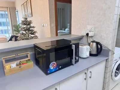 a microwave oven on a counter in a kitchen at Elegant 1BR Apartment in Dubai LuxuryStay in Dubai