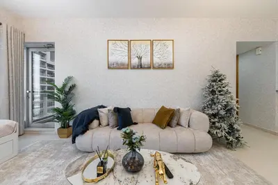 a living room with a couch and a christmas tree at Elegant 1BR Apartment in Dubai LuxuryStay in Dubai