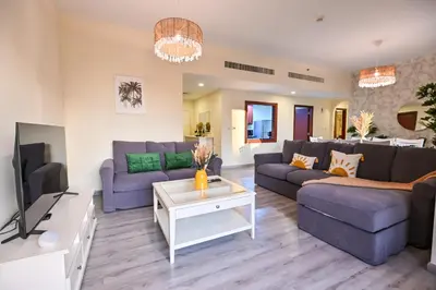 a living room with purple couches and a tv at 7 Beds - JBR Beach 3 min walk in Dubai