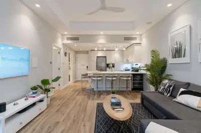 a large living room with a couch and a kitchen at Lovey Unique Property- Garden and Barbeque Area in Dubai