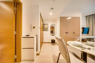a kitchen and dining room with a table and chairs at Wonderful New Studio in Missoni Business Bay in Dubai