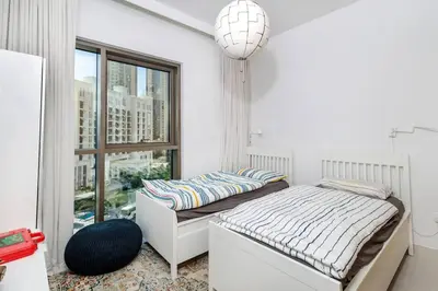 a bedroom with two beds and a window at 3 BR Dubai Creek Harbour in Dubai