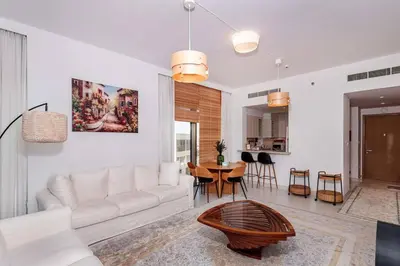 a living room with a white couch and a table at 3 BR Dubai Creek Harbour in Dubai