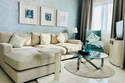 a living room with a couch and a table at Vserve - 1 BR Iconic Burj Khalifa full view in Dubai