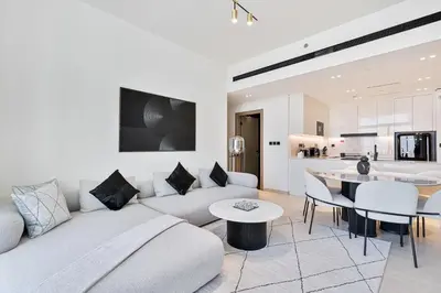 a living room with a couch and a table at Elegant - 3BR - near Palm Jumeirah - Pool and Gym in Dubai