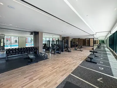 a gym with treadmills and exercise equipment in a building at Elegant - 3BR - near Palm Jumeirah - Pool and Gym in Dubai
