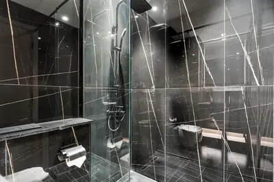 a bathroom with a shower with a glass door at Elegant - 3BR - near Palm Jumeirah - Pool and Gym in Dubai