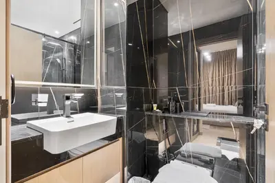 a bathroom with a white sink and a mirror at Elegant - 3BR - near Palm Jumeirah - Pool and Gym in Dubai