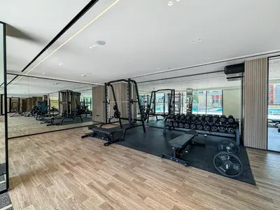 a gym with treadmills and exercise equipment in a building at Elegant - 3BR - near Palm Jumeirah - Pool and Gym in Dubai
