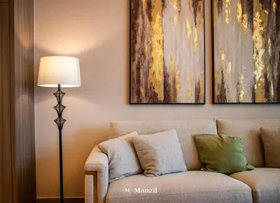 a living room with a couch and a lamp at Manzil - 2BR Apartment in Palm Jumeirah with Marina View in Dubai