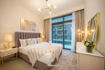 a bedroom with a bed and a large window at Manzil - 2BR Apartment in Palm Jumeirah with Marina View in Dubai