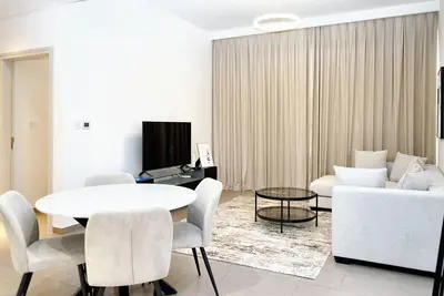 a living room with a white table and a couch at First class 1BR Hall in Park Heights in Dubai