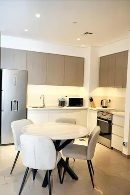a kitchen with a table and chairs in a room at First class 1BR Hall in Park Heights in Dubai