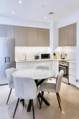 a kitchen with a table and chairs in a room at First class 1BR Hall in Park Heights in Dubai