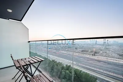 a balcony with a bench and a view of a highway at Elegant Studio in Bloom Towers B, JVC by Deluxe Holiday Homes in Dubai