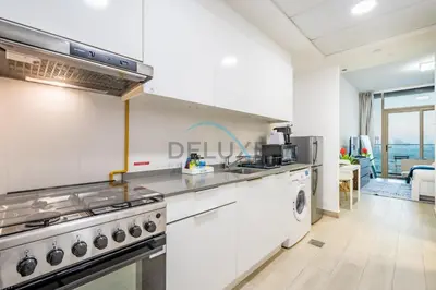 a kitchen with a stove and a dishwasher at Elegant Studio in Bloom Towers B, JVC by Deluxe Holiday Homes in Dubai