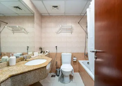 a bathroom with a toilet and a sink and a tub at Perfect Stay - 1Bedroom with full Marina View in Dubai
