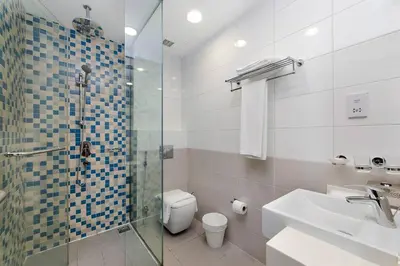 a bathroom with a shower and a toilet and a sink at Free Netflix, Sea View, Private Beach & Pool in Dubai