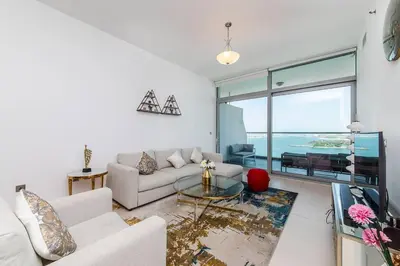 a living room with a couch and a table at Free Netflix, Sea View, Private Beach & Pool in Dubai