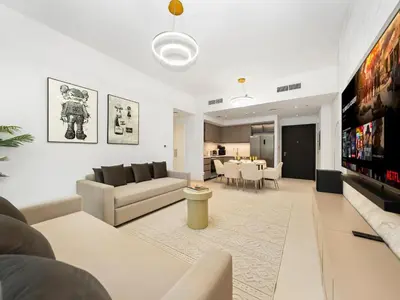 a living room with a couch and a table at Luxury Downtown Dubai Apartment - 5 Mins Walk to Burj, Opera, Dubai Mall, Sleep 1-10 in Dubai