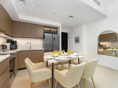 a kitchen and dining room with a table and chairs at Luxury Downtown Dubai Apartment - 5 Mins Walk to Burj, Opera, Dubai Mall, Sleep 1-10 in Dubai