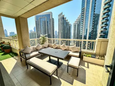 a balcony with a table and chairs and a view of a city at Vserve - 1 BR Spacious Majestic Burj Khalifa view in Dubai