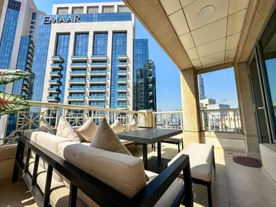 a balcony with couches and a table on a building at Vserve - 1 BR Spacious Majestic Burj Khalifa view in Dubai
