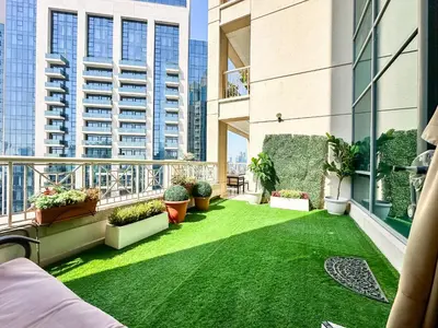 a balcony with green grass and plants on a building at Vserve - 1 BR Spacious Majestic Burj Khalifa view in Dubai