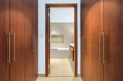 a bathroom with wooden cabinets and a bathroom with a tub at Skyline Views 2BR Near Burj Khalifa & Dubai Mall with Pool Access in Dubai