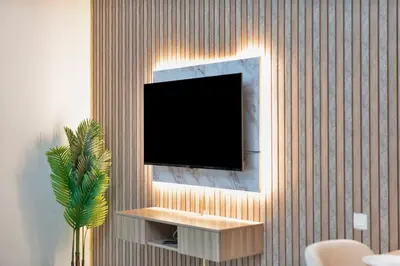 a flat screen tv hanging on a wall at Chic Studio Stay with Gym, Pool, and Kitchenette in Dubai