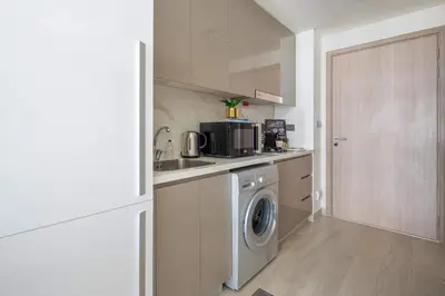 a kitchen with a washing machine and a washer at Frank Porter - Azizi Riviera 28 in Dubai