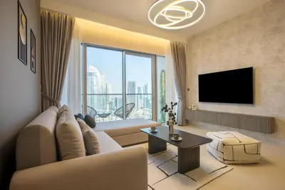 a living room with a couch and a tv at Burj Khalifa & Fountain Views, Pool, Free Parking in Dubai