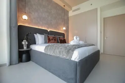 a bedroom with a large bed in a room at Burj Khalifa & Fountain Views, Pool, Free Parking in Dubai