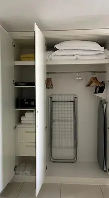 a bedroom with a closet with a bed in it at Downtown Dubai - Damac Maison Mall Street in Dubai