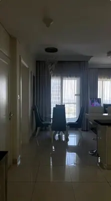 a living room with blue chairs and a table at Downtown Dubai - Damac Maison Mall Street in Dubai