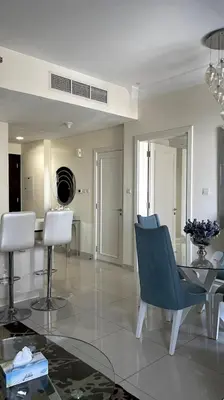 a living room with a table and chairs at Downtown Dubai - Damac Maison Mall Street in Dubai